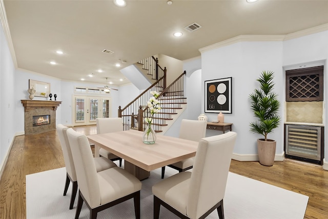 2403 Commonwealth St, Houston, TX 77006 - dining room featuring beverage cooler, stairway, wood finished floors, a fireplace, and recessed lighting