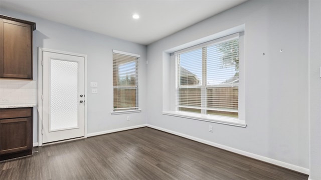 18010 Wagstaff Way, Richmond, TX 77407 - unfurnished dining area with dark wood-style flooring and baseboards