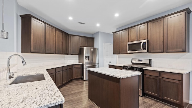 18010 Wagstaff Way, Richmond, TX 77407 - kitchen with appliances with stainless steel finishes, a sink, backsplash, dark wood finished floors, and recessed lighting
