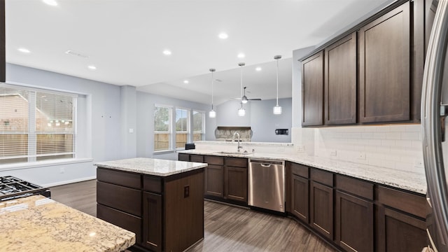 18010 Wagstaff Way, Richmond, TX 77407 - kitchen featuring dishwasher, a sink, dark wood-style flooring, tasteful backsplash, and dark brown cabinets