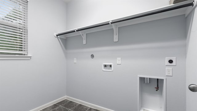 18010 Wagstaff Way, Richmond, TX 77407 - washroom with electric dryer hookup, gas dryer hookup, hookup for a washing machine, baseboards, and dark tile patterned flooring