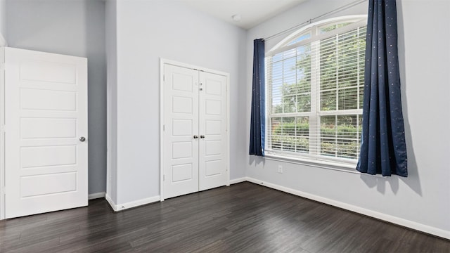 18010 Wagstaff Way, Richmond, TX 77407 - unfurnished bedroom featuring dark wood-type flooring, a closet, and baseboards