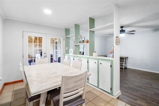104 Meadowlark Ln, Angleton, TX 77515 - dining room featuring french doors, crown molding, ceiling fan, baseboards, and light wood-style flooring