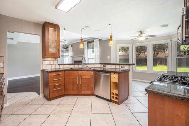 311 Vantage Pointe Cir, League City, TX 77573 - kitchen featuring appliances with stainless steel finishes, a sink, ceiling fan, ornamental molding, and light tile patterned flooring