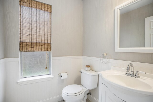 311 Vantage Pointe Cir, League City, TX 77573 - bathroom with toilet, vanity, and a wainscoted wall