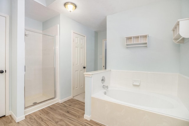 311 Vantage Pointe Cir, League City, TX 77573 - full bath with wood finished floors, a bath, a shower stall, and baseboards