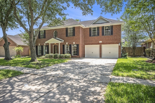 311 Vantage Pointe Cir, League City, TX 77573 - view of front of property with driveway, a garage, and brick siding