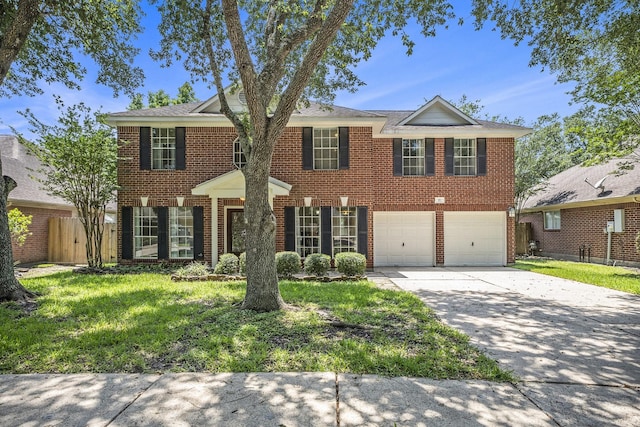 311 Vantage Pointe Cir, League City, TX 77573 - view of front of home with driveway, brick siding, a garage, and a front lawn