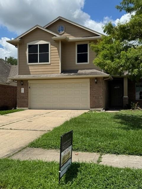 25227 Twister Trl, Spring, TX 77373 - view of front of property featuring brick siding, a garage, concrete driveway, and a front lawn
