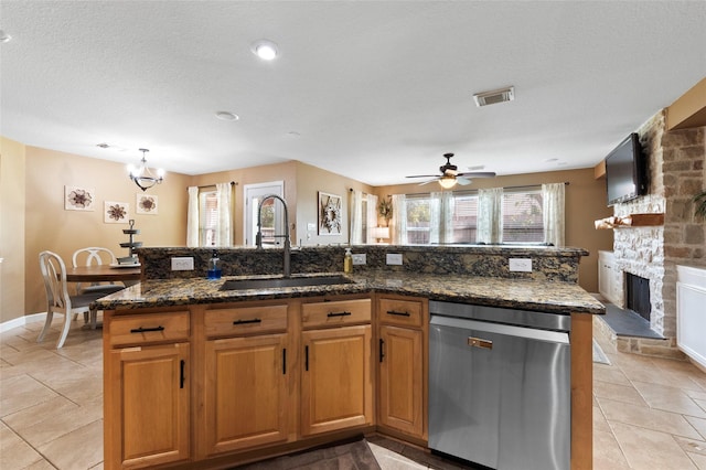 3803 Shiloh Park Ct, Friendswood, TX 77546 - kitchen featuring stainless steel dishwasher, a sink, ceiling fan, light tile patterned floors, and a center island with sink
