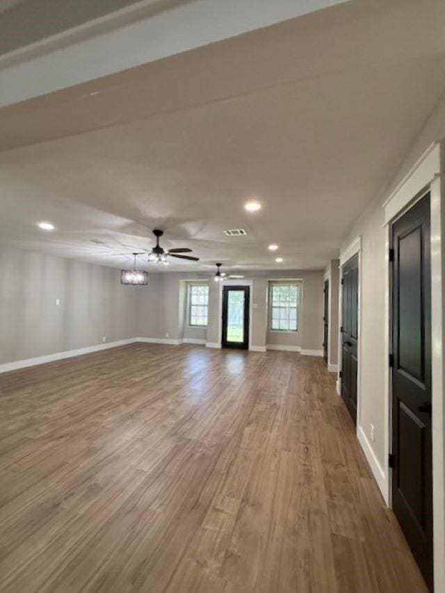674 Meadowgreen Dr, Port Neches, TX 77651 - unfurnished living room featuring wood finished floors, baseboards, recessed lighting, and a ceiling fan