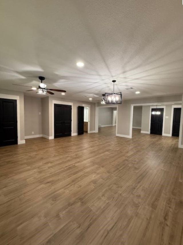 674 Meadowgreen Dr, Port Neches, TX 77651 - unfurnished living room featuring a chandelier, baseboards, recessed lighting, wood finished floors, and a ceiling fan
