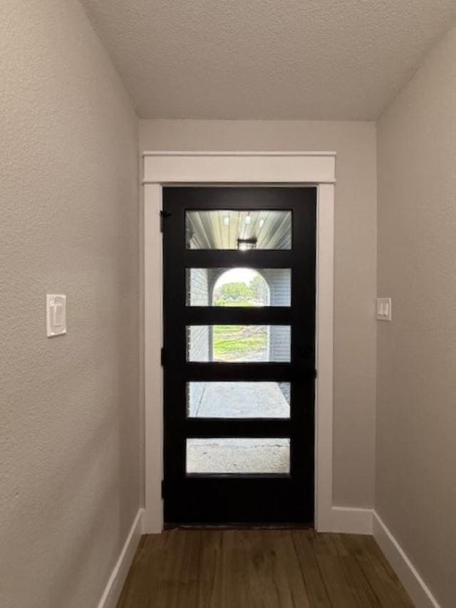 674 Meadowgreen Dr, Port Neches, TX 77651 - entrance foyer featuring baseboards, wood finished floors, a textured ceiling, and a textured wall