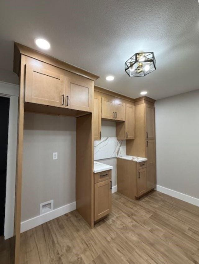 674 Meadowgreen Dr, Port Neches, TX 77651 - kitchen with light wood-style floors, baseboards, light countertops, and recessed lighting