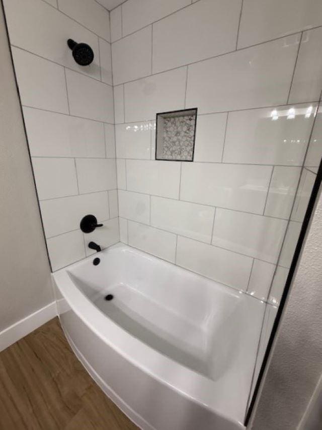 674 Meadowgreen Dr, Port Neches, TX 77651 - full bathroom with wood finished floors, baseboards, and shower / washtub combination