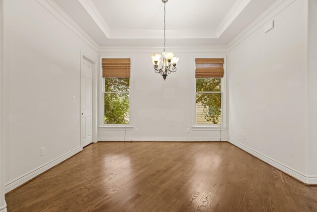 9269 Buffalo Speedway, Houston, TX 77025 - unfurnished dining area with a chandelier, wood finished floors, a raised ceiling, baseboards, and ornamental molding
