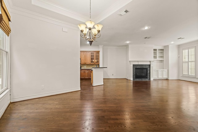 9269 Buffalo Speedway, Houston, TX 77025 - unfurnished living room featuring ornamental molding, a chandelier, dark wood finished floors, a premium fireplace, and recessed lighting