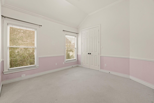 9269 Buffalo Speedway, Houston, TX 77025 - empty room featuring crown molding, vaulted ceiling, carpet, a wainscoted wall, and baseboards