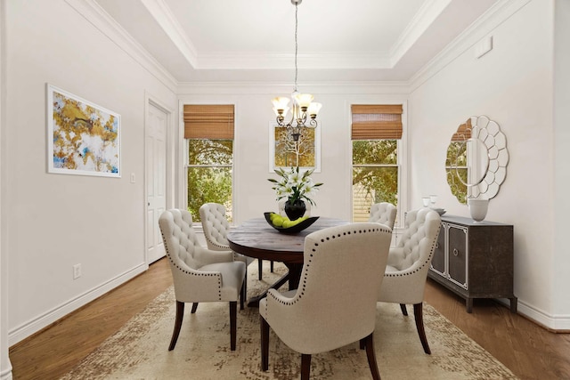 9269 Buffalo Speedway, Houston, TX 77025 - dining space with a chandelier, a raised ceiling, wood finished floors, baseboards, and crown molding