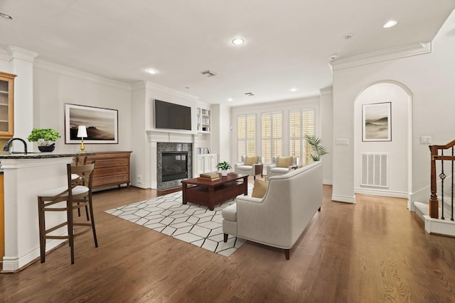 9269 Buffalo Speedway, Houston, TX 77025 - living area with wood finished floors, ornamental molding, a fireplace, recessed lighting, and stairway