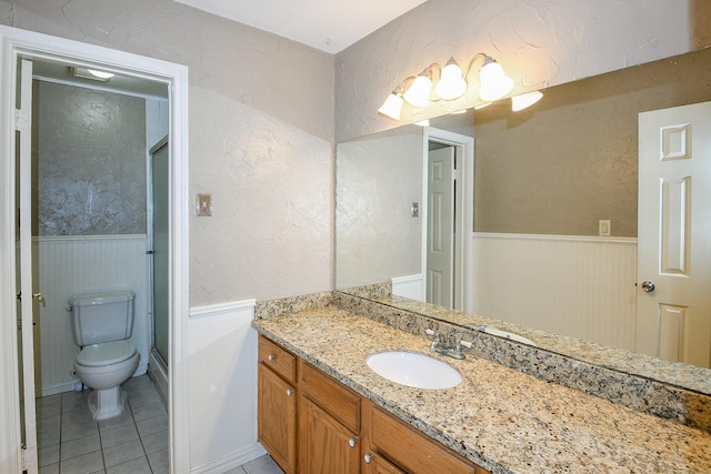 1083 County Rd 147, Alvin, TX 77511 - full bathroom with a wainscoted wall, vanity, toilet, tile patterned flooring, and a textured wall