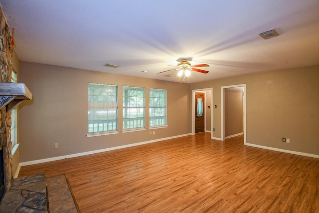 1083 County Rd 147, Alvin, TX 77511 - unfurnished living room with light wood-style flooring, ceiling fan, and baseboards