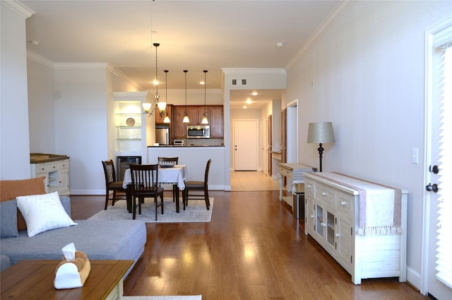 2203 Dorrington St Unit 403, Houston, TX 77030 - living area featuring wood finished floors, crown molding, and baseboards