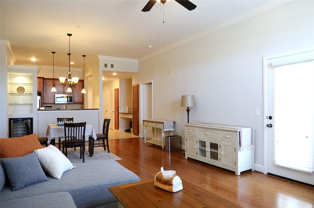 2203 Dorrington St Unit 403, Houston, TX 77030 - living room featuring wood finished floors, a chandelier, ceiling fan, ornamental molding, and beverage cooler