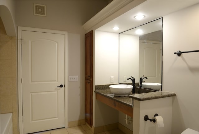 2203 Dorrington St Unit 403, Houston, TX 77030 - bathroom featuring a sink, a bathtub, tile patterned flooring, baseboards, and recessed lighting