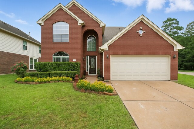 9210 E Lakeside Dr, Magnolia, TX 77354 - traditional home featuring brick siding, concrete driveway, a front lawn, and an attached garage