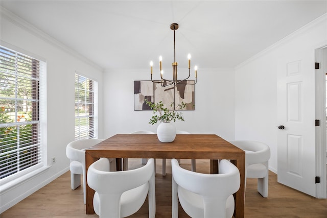10310 Minturn Ln, Houston, TX 77064 - dining area with a chandelier, ornamental molding, light wood-style flooring, and baseboards