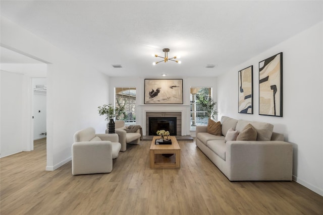 10310 Minturn Ln, Houston, TX 77064 - living area with healthy amount of natural light, light wood-type flooring, baseboards, and a chandelier