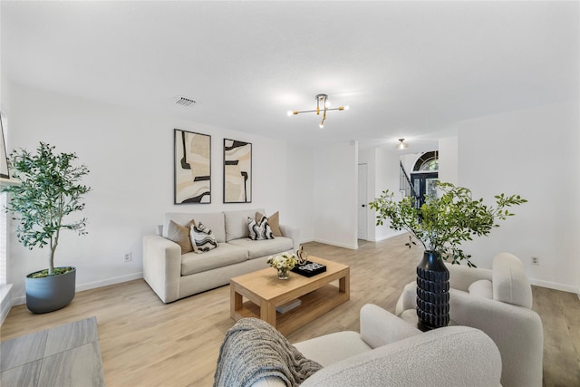 10310 Minturn Ln, Houston, TX 77064 - living room with light wood-type flooring, a chandelier, and baseboards