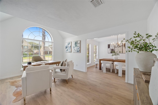 10310 Minturn Ln, Houston, TX 77064 - living room with a chandelier, vaulted ceiling, light wood-style flooring, and baseboards