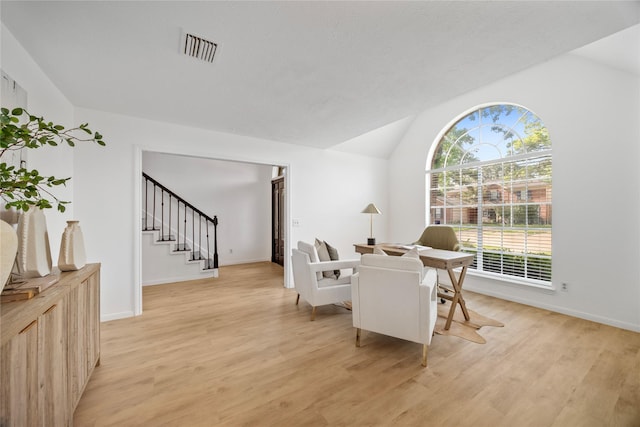 10310 Minturn Ln, Houston, TX 77064 - dining room featuring light wood-style flooring, lofted ceiling, stairway, and baseboards