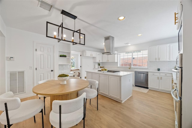 10310 Minturn Ln, Houston, TX 77064 - kitchen with dishwasher, island exhaust hood, decorative backsplash, white cabinets, and light wood-style flooring