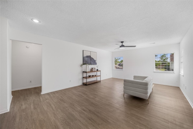 10310 Minturn Ln, Houston, TX 77064 - sitting room with a textured ceiling, wood finished floors, a ceiling fan, and baseboards