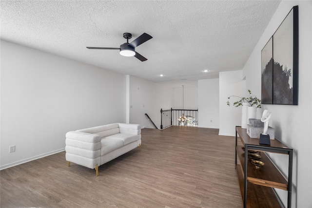 10310 Minturn Ln, Houston, TX 77064 - sitting room featuring an upstairs landing, wood finished floors, a ceiling fan, a textured ceiling, and recessed lighting
