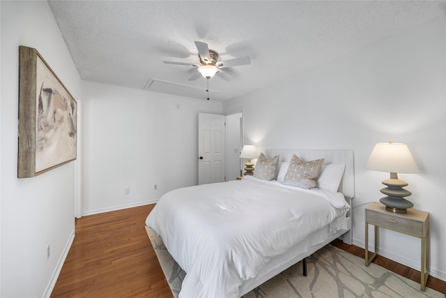10310 Minturn Ln, Houston, TX 77064 - bedroom with baseboards, wood finished floors, attic access, a textured ceiling, and ceiling fan