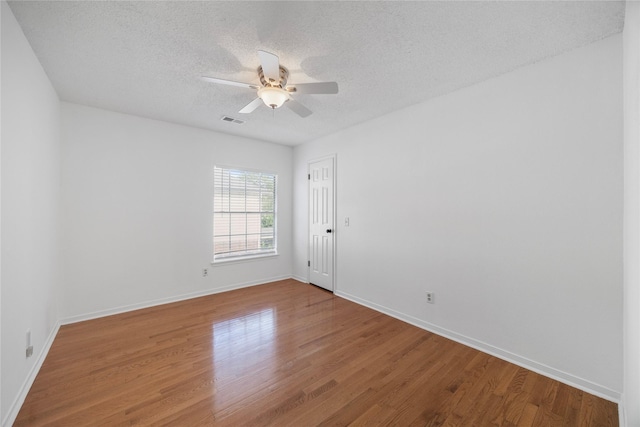 10310 Minturn Ln, Houston, TX 77064 - empty room with a textured ceiling, wood finished floors, ceiling fan, and baseboards