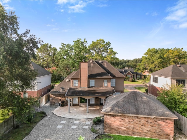 10310 Minturn Ln, Houston, TX 77064 - back of house with brick siding, a fenced backyard, a chimney, and roof with shingles