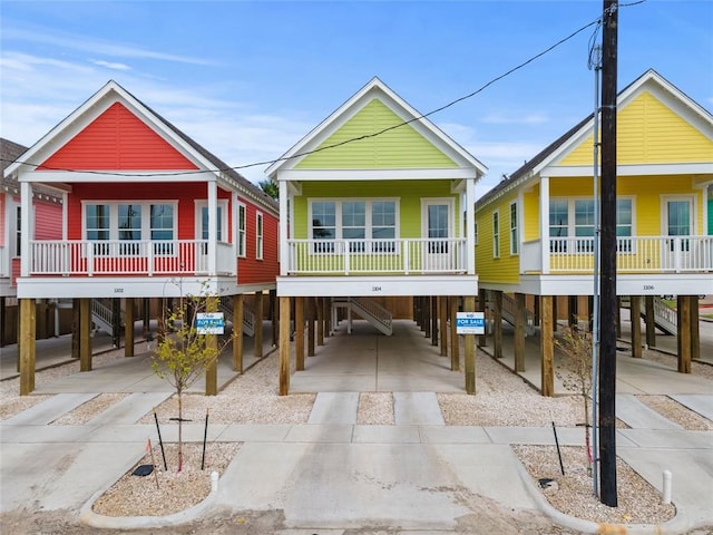 1104 62nd St, Galveston, TX 77551 - view of front facade with a carport, driveway, and covered porch
