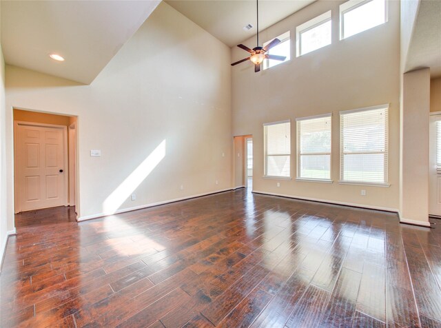 9110 Darby Park Ln, Richmond, TX 77407 - unfurnished living room featuring a towering ceiling, ceiling fan, and hardwood / wood-style floors