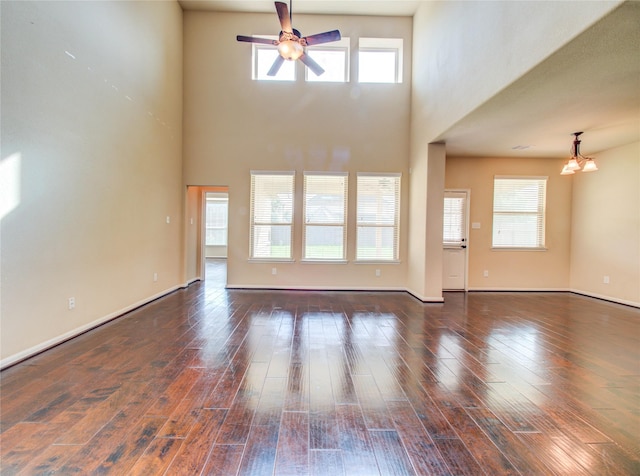 9110 Darby Park Ln, Richmond, TX 77407 - unfurnished living room with a ceiling fan, hardwood / wood-style floors, and a high ceiling