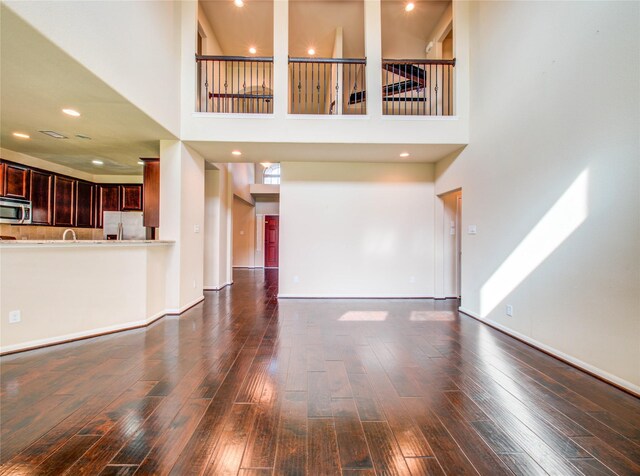 9110 Darby Park Ln, Richmond, TX 77407 - unfurnished living room with wood-type flooring and a high ceiling