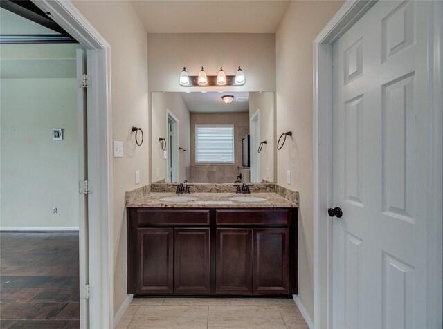 9110 Darby Park Ln, Richmond, TX 77407 - bathroom with double vanity and baseboards