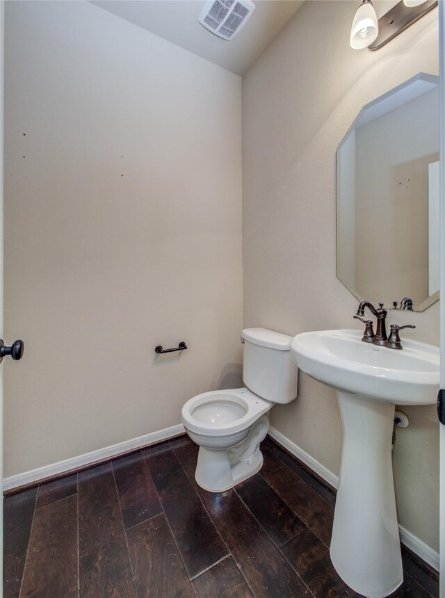 9110 Darby Park Ln, Richmond, TX 77407 - half bath featuring toilet and wood finished floors