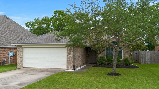 206 Rippling Creek Ln, Alvin, TX 77511 - view of front of house featuring an attached garage, driveway, roof with shingles, and brick siding