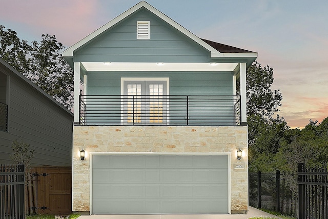 786 Lucky St, Houston, TX 77088 - view of front facade featuring stone siding, an attached garage, and driveway
