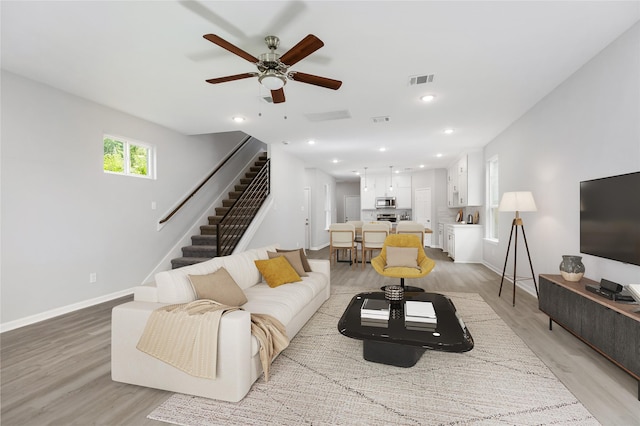 786 Lucky St, Houston, TX 77088 - living area with light wood-style flooring, stairs, ceiling fan, baseboards, and recessed lighting
